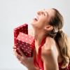 Woman opening the gift and is happy