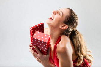 Woman opening the gift and is happy